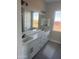 Double vanity bathroom with quartz countertop and modern fixtures at 28304 N 220Th Ave, Wittmann, AZ 85361