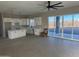 Modern kitchen with white cabinets, island, and sliding door access to patio at 28304 N 220Th Ave, Wittmann, AZ 85361