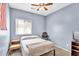 Inviting carpeted bedroom bathed in natural light, complete with a ceiling fan and cozy furnishings for serene relaxation at 2865 E Cathy Dr, Gilbert, AZ 85296