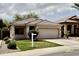 Charming single-story home featuring a well-manicured lawn, tile roof, and an attached two-car garage at 2865 E Cathy Dr, Gilbert, AZ 85296