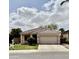 Charming single-story home features a tile roof, two-car garage, well-maintained lawn, and desert landscaping at 2865 E Cathy Dr, Gilbert, AZ 85296