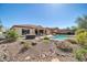 Beautiful backyard showcasing a pool, spa, covered patio, and built-in barbecue area for outdoor entertaining at 30696 N 130Th Ln, Peoria, AZ 85383