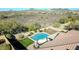 Aerial view of a backyard featuring a pool, patio, manicured lawn, and desert landscaping at 30696 N 130Th Ln, Peoria, AZ 85383