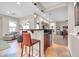 Open floorplan featuring a bar area with seating and built in refrigerator at 30696 N 130Th Ln, Peoria, AZ 85383