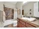 Updated bathroom with a vanity, framed mirror, and a bathtub with tiled walls and a shower curtain at 30696 N 130Th Ln, Peoria, AZ 85383