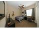 Cozy bedroom with a comfortable bed, desk, and guitar at 30696 N 130Th Ln, Peoria, AZ 85383