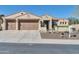 Inviting home featuring a 3-car garage, desert landscaping, and classic Southwestern architecture at 30696 N 130Th Ln, Peoria, AZ 85383