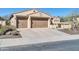 Inviting home featuring a 3-car garage, desert landscaping, and classic Southwestern architecture at 30696 N 130Th Ln, Peoria, AZ 85383