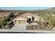 Charming single-story home with a tile roof, three-car garage, and landscaped front yard at 30696 N 130Th Ln, Peoria, AZ 85383