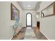 Inviting foyer with an ornate arched doorway, decorative mirror, and stylish table at 30696 N 130Th Ln, Peoria, AZ 85383