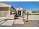 Well-maintained front yard with desert landscaping and a charming walkway leading to the entrance at 30696 N 130Th Ln, Peoria, AZ 85383