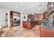Kitchen with large stainless refrigerator, island, granite counters, and custom cabinetry at 30696 N 130Th Ln, Peoria, AZ 85383