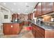 This kitchen features an island with dark countertops, lots of wooden cabinets, and stainless steel appliances at 30696 N 130Th Ln, Peoria, AZ 85383