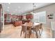 Spacious eat-in kitchen featuring granite countertops, island, stainless appliances, and beautiful tile flooring at 30696 N 130Th Ln, Peoria, AZ 85383