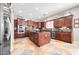 Gourmet kitchen with large island, granite counters, stainless steel appliances, and custom cabinetry at 30696 N 130Th Ln, Peoria, AZ 85383