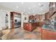 Spacious kitchen with stainless steel appliances, dark wood cabinetry, and granite countertops at 30696 N 130Th Ln, Peoria, AZ 85383