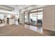 Bright living area features tiled floors, a bar top, and access to the outdoor pool and patio at 30696 N 130Th Ln, Peoria, AZ 85383