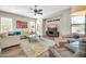 The living room offers neutral walls, modern decor, and lots of light from the windows, and tiled floors at 30696 N 130Th Ln, Peoria, AZ 85383