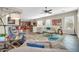 The living room features tiled floors and neutral walls, with an open floorplan into the kitchen and dining area at 30696 N 130Th Ln, Peoria, AZ 85383