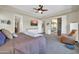 Main bedroom with a large window, ceiling fan, and neutral color palette at 30696 N 130Th Ln, Peoria, AZ 85383