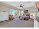 Bright main bedroom with large windows, a ceiling fan, and neutral tones at 30696 N 130Th Ln, Peoria, AZ 85383