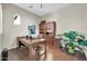 Well-lit home office with wood floors, a built-in bookcase, and large desk at 30696 N 130Th Ln, Peoria, AZ 85383