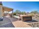 Inviting covered patio with brick pavers, featuring a spa and outdoor dining area with a barbecue at 30696 N 130Th Ln, Peoria, AZ 85383