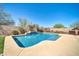 Beautiful backyard pool with waterfall feature, set against a brick wall and lush landscaping at 30696 N 130Th Ln, Peoria, AZ 85383