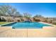 Sparkling backyard pool with waterfall and clean concrete surround, enclosed by a decorative brick wall at 30696 N 130Th Ln, Peoria, AZ 85383
