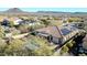 Aerial shot of a home featuring a sparkling blue pool, covered patio, and desert landscape at 30696 N 130Th Ln, Peoria, AZ 85383