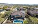 Stunning aerial view of the backyard with a pool, hot tub, patio and solar panels at 30696 N 130Th Ln, Peoria, AZ 85383