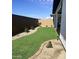 Landscaped backyard with artificial turf and sitting area at 39190 N Kaden Ln, San Tan Valley, AZ 85140