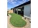 Landscaped backyard with artificial turf and sitting area at 39190 N Kaden Ln, San Tan Valley, AZ 85140