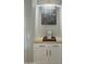 Built-in coffee bar with white cabinets and a neutral countertop at 39190 N Kaden Ln, San Tan Valley, AZ 85140