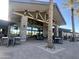 Community clubhouse with outdoor seating and a stone fireplace at 39190 N Kaden Ln, San Tan Valley, AZ 85140