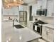 Modern kitchen with white cabinets, quartz countertops, and stainless steel appliances at 39190 N Kaden Ln, San Tan Valley, AZ 85140