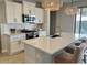 Spacious kitchen island with white quartz countertop and seating at 39190 N Kaden Ln, San Tan Valley, AZ 85140
