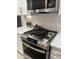 Modern kitchen features stainless steel appliances and white cabinetry at 39190 N Kaden Ln, San Tan Valley, AZ 85140