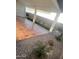 Covered patio with terracotta tile flooring, artificial turf, and desert landscaping at 39190 N Kaden Ln, San Tan Valley, AZ 85140