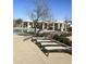 Relaxing pool area with lounge chairs and shade structures at 39190 N Kaden Ln, San Tan Valley, AZ 85140