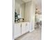 Built-in wet bar with white cabinets and a wood countertop at 39190 N Kaden Ln, San Tan Valley, AZ 85140