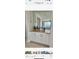 White wet bar with wood countertop and wine glass holders at 39190 N Kaden Ln, San Tan Valley, AZ 85140