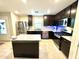 Modern kitchen with dark cabinets, granite countertops, and stainless steel appliances at 3937 S 79Th Ln, Phoenix, AZ 85043