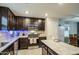 Charming kitchen featuring stainless steel appliances, dark wood cabinetry and granite countertops at 3937 S 79Th Ln, Phoenix, AZ 85043