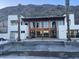 Back exterior view of house with pool and mountain backdrop at 5000 N Camelback Ridge Dr # 107, Scottsdale, AZ 85251