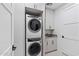 Modern laundry room with washer, dryer, and built-in cabinets at 5000 N Camelback Ridge Dr # 107, Scottsdale, AZ 85251