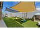 Backyard with artificial turf, play structures, and shade sail at 730 W El Alba Way, Chandler, AZ 85225