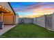Artificial turf backyard with covered patio and hanging chair at 730 W El Alba Way, Chandler, AZ 85225