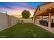 Landscaped backyard with artificial turf and patio area at 730 W El Alba Way, Chandler, AZ 85225