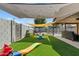 Backyard with artificial turf, play structures, and shade sail at 730 W El Alba Way, Chandler, AZ 85225